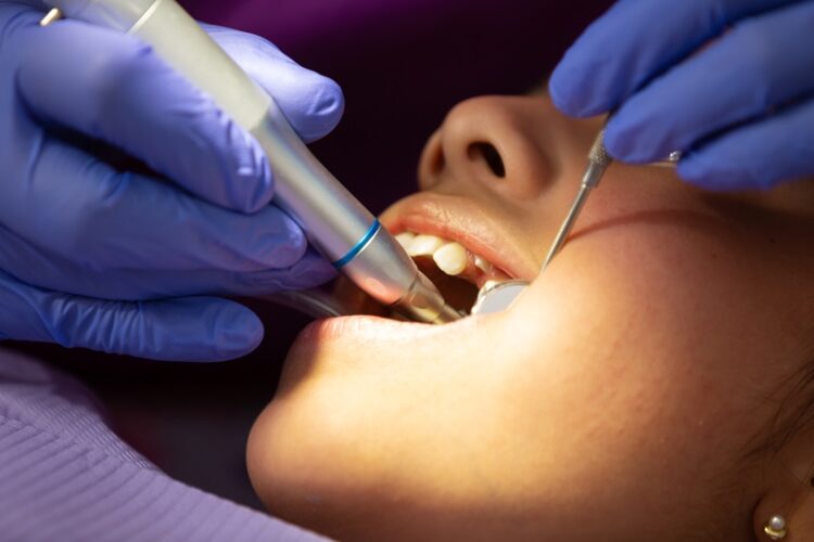 Closeup of a dentist doing dental treatment on a young Mexican girl